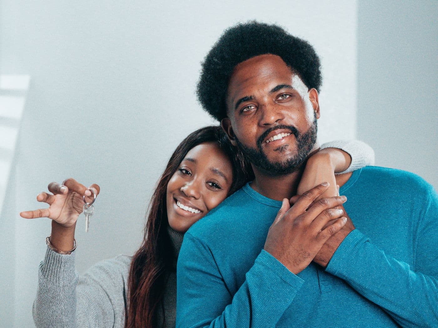 Happy couple holding the keys to their home